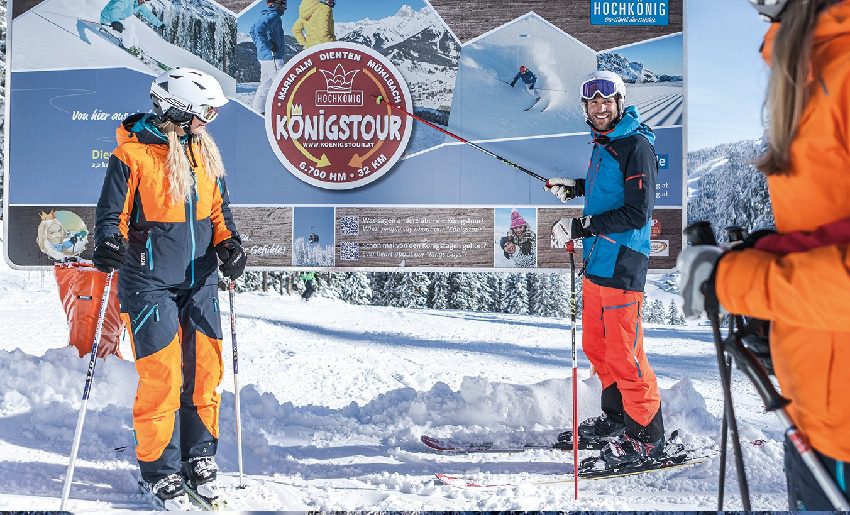 People Skiing by Sign